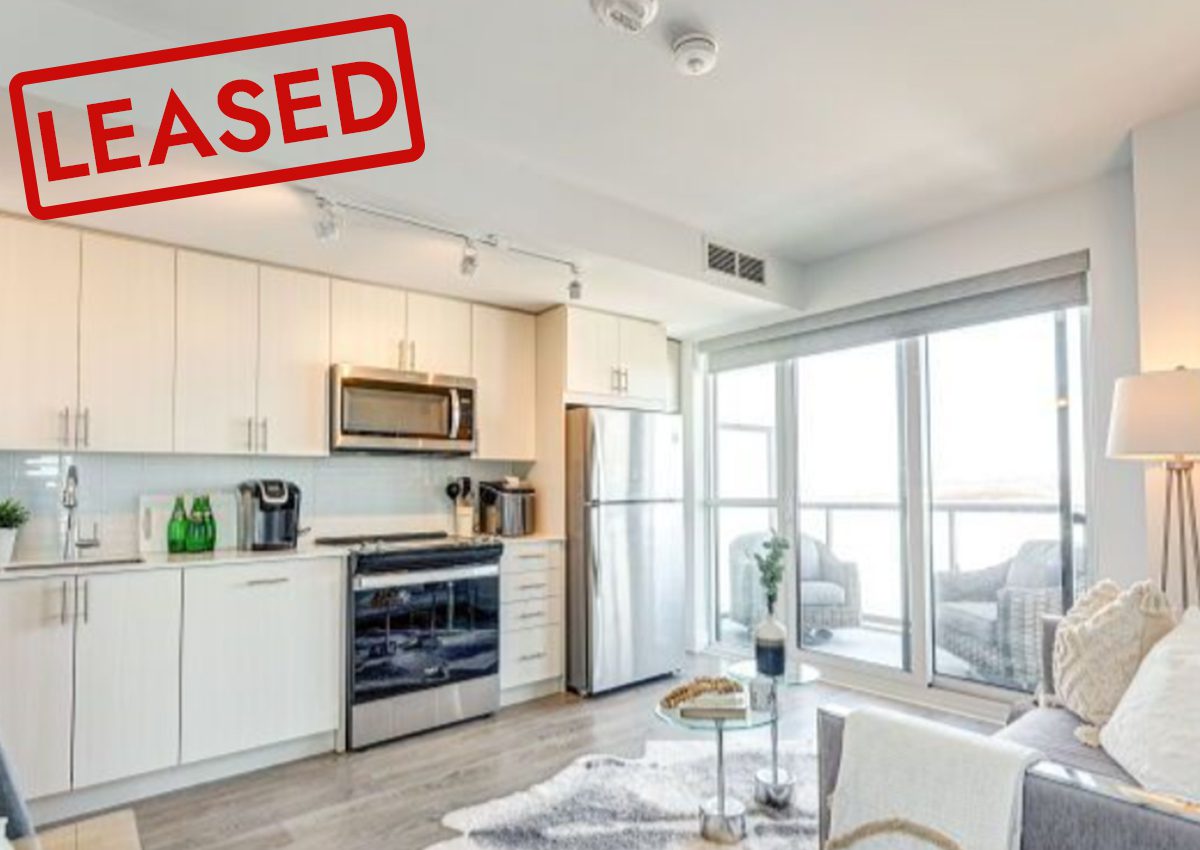 Modern kitchen with stainless steel appliances and bright natural light.