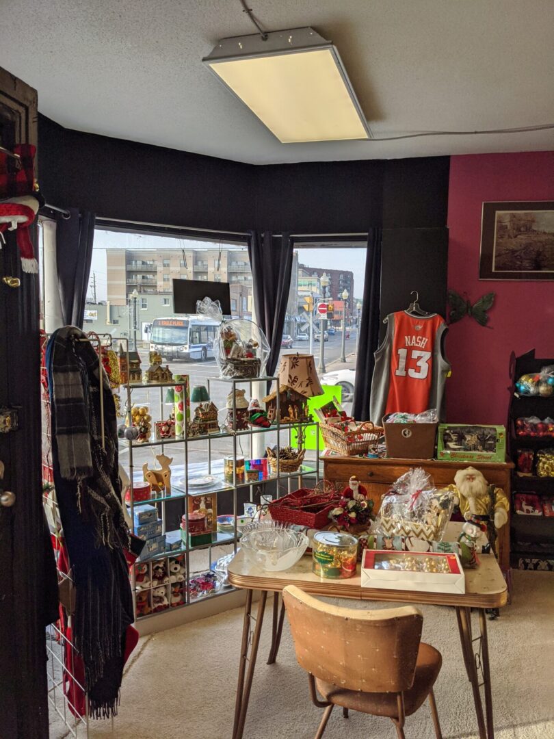 Cozy gift shop with various items displayed near windows and shelves.