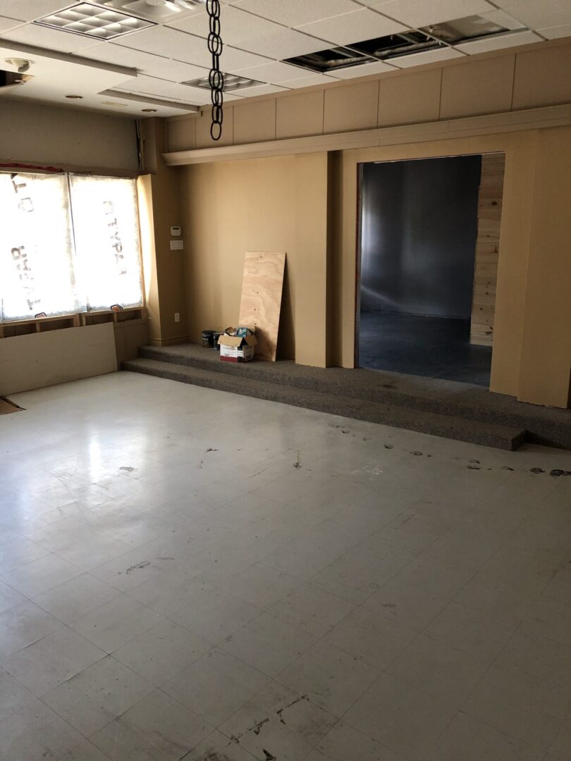 Empty room with a raised platform and large window.