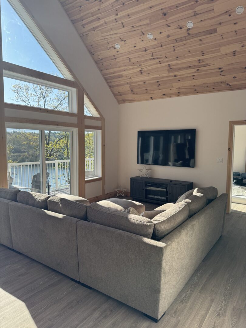 Cozy living room with a large sectional sofa and wall-mounted TV.